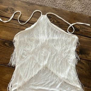 White tank, ties around the neck with fringe.